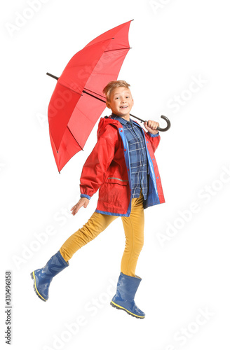 Jumping little boy with umb...