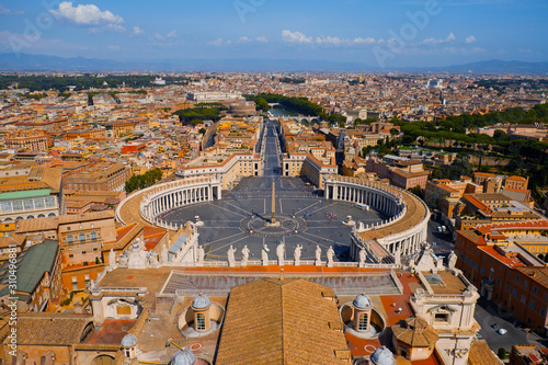 Vatican City view from the top of St. Peter's Basilica in Rome, Italy. Looking down over Piazza San Pietro in Vatican. Saint Peter's Square and aerial view of Roma. Famous travel destination.