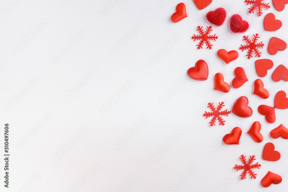 Festive composition from red hearts and snowflakes scattered on white background, valentines day concept, copy space
