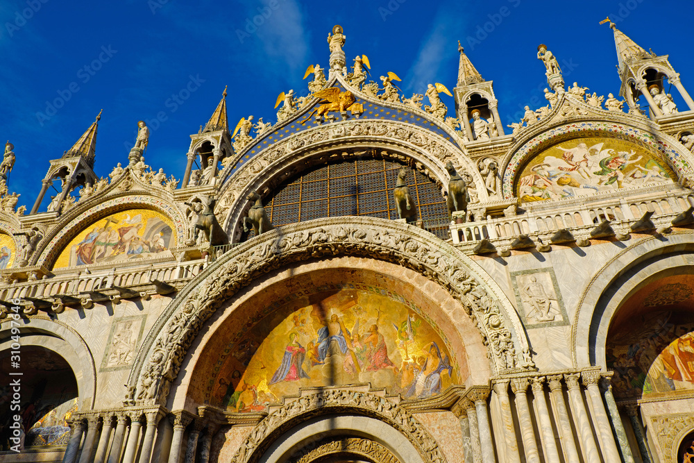 Basilica di San Marco under blue sky, Venice, Italy. Saint Mark Basilica and Doge's Palace. Cathedral of San Marco. Roof architecture details with lion, symbol of the City of Venice. 