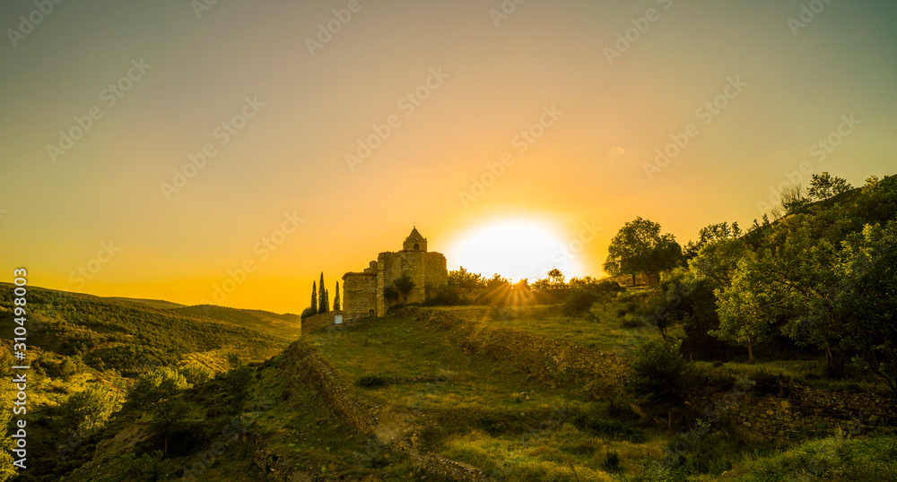 villages of the sierra sunset over church and ancient walls