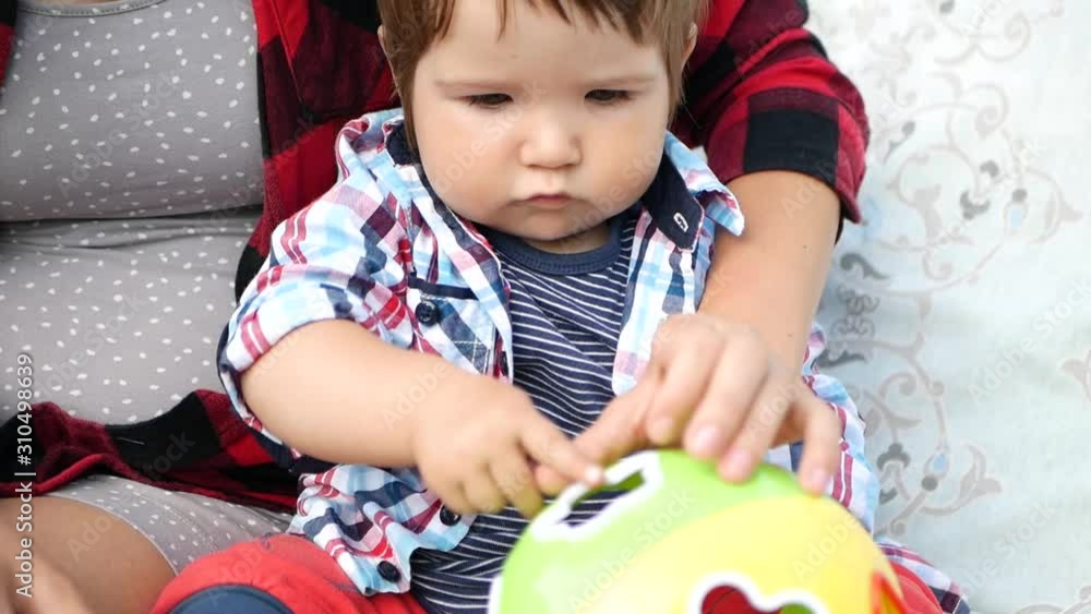 Mom plays educational toys with a small child. Children play with colorful toys. Baby development. infancy. Mom plays educational toys with a small child. Children play with colorful toys. Baby development. infancy.