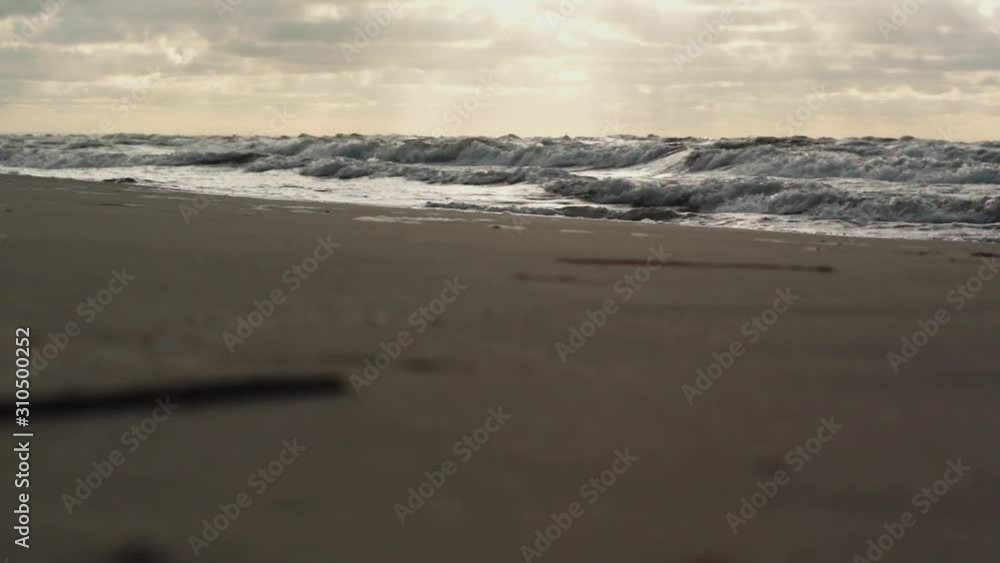 Landscape with a sunset over beach with a high sea waves Landscape with a sunset over beach with a high sea waves