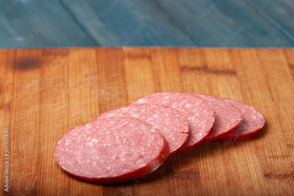 slicing sausage on a cutting Board slicing sausage on a cutting Board