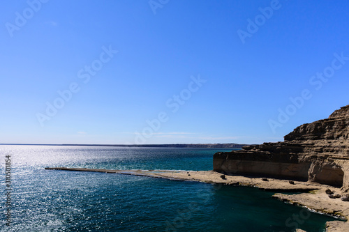 Panoramic view of Gulf Nuevo during sunny clear sky day in Puerto Piramides, Peninsula Valdes,