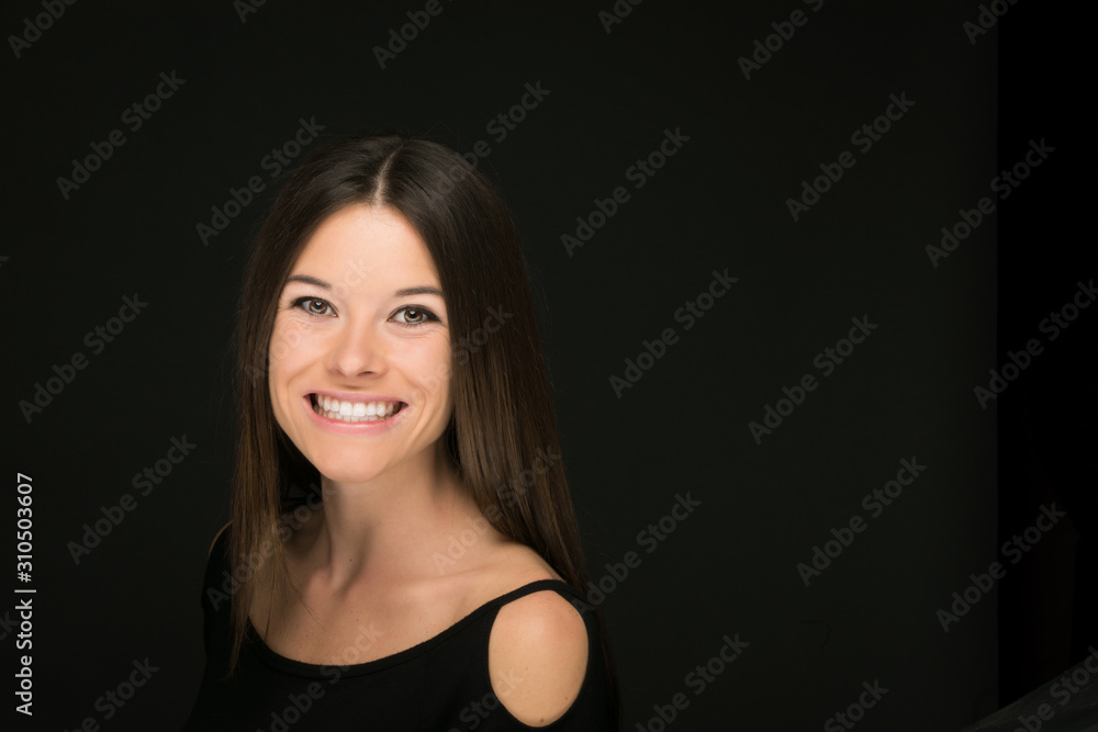 Smiling young woman on black background Smiling young woman on black background