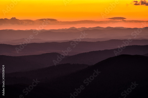 Splendid mountain sunrise. Mountains silhouettes on a beauty background. Bieszczady Mountains Poland.