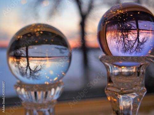 Winter sunset on lake lansing reflected in glass globe © PamelaCarpenter