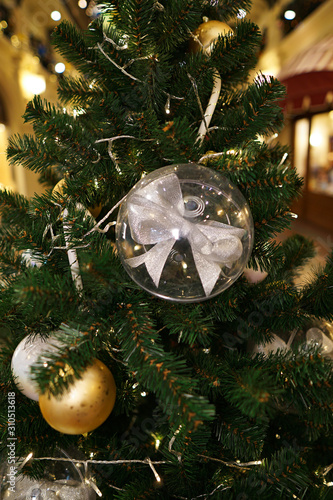 Christmas decorations on the Christmas tree. Transparent balls with a bow inside.