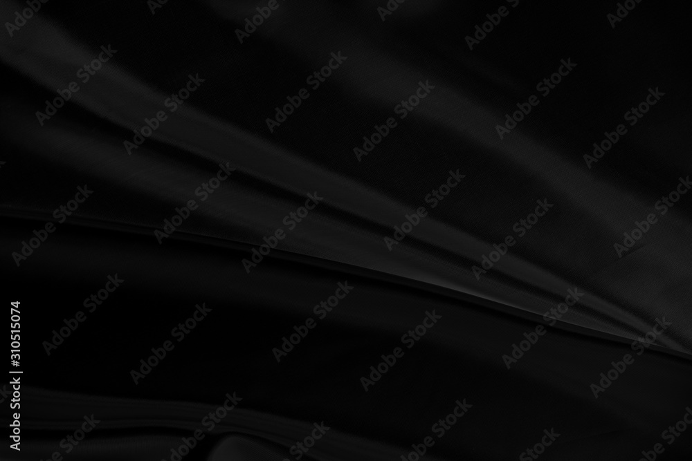 Black gray satin dark fabric texture luxurious shiny that is abstract silk cloth background with patterns soft waves blur beautiful. Black gray satin dark fabric texture luxurious shiny that is abstract silk cloth background with patterns soft waves blur beautiful.