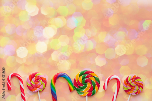 Lollipops on a colored background. Christmas concept. Copy space. Top view.