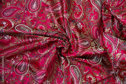 red paisley satin fabric background