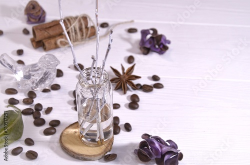 Handmade flavoring for home, coffee, grains, anise, cinnamon on a white wooden background with space for text. 