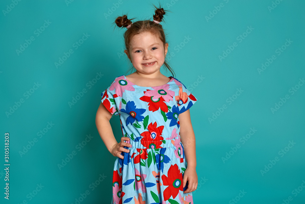 Little girl in on a blue background. Emotions of a child are anger, resentment, joy. Charming little girl smiling and showing her first lost milk tooth. Little girl in on a blue background. Emotions of a child are anger, resentment, joy. Charming little girl smiling and showing her first lost milk tooth.