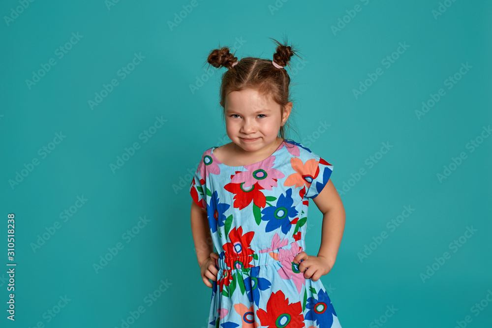 Little girl in on a blue background. Emotions of a child are anger, resentment, joy. Charming little girl smiling and showing her first lost milk tooth. Little girl in on a blue background. Emotions of a child are anger, resentment, joy. Charming little girl smiling and showing her first lost milk tooth.