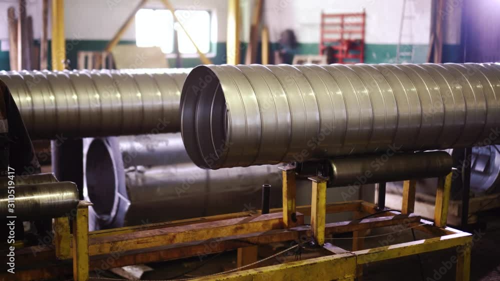 Transporter line with tube moving and rotating in workshop at factory. Metal works and manufacturing, processing wuth metal details, pipes. Transporter line with tube moving and rotating in workshop at factory. Metal works and manufacturing, processing wuth metal details, pipes.