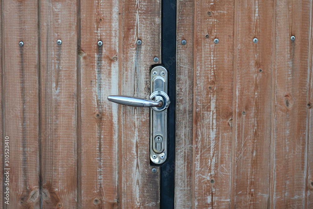 soft focus metal handle on a old wooden door