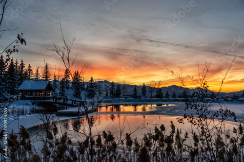 Pond and House with Snowy Sunset