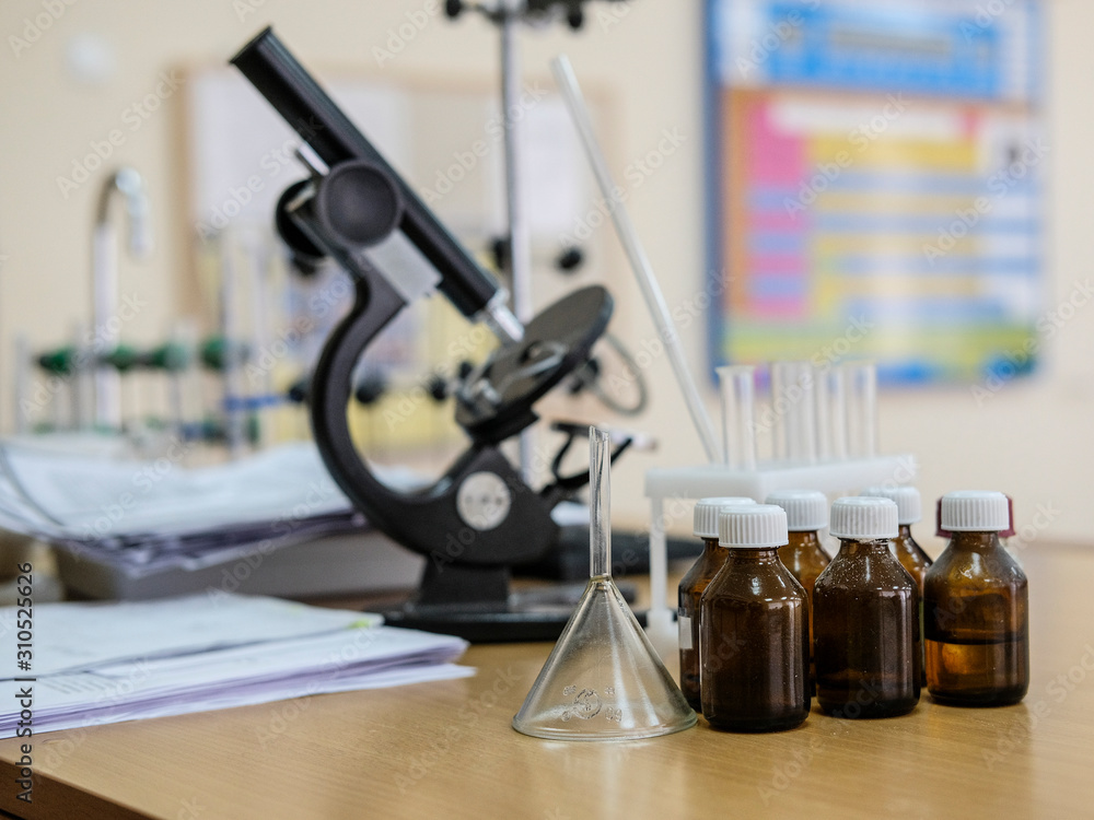 image of a microscope and test tubes on the desktop image of a microscope and test tubes on the desktop