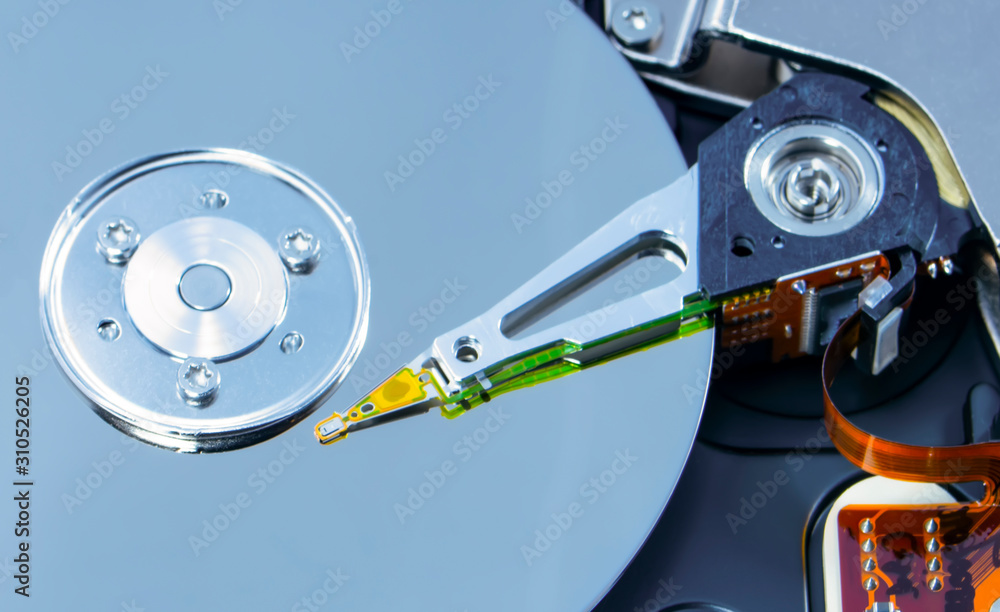 Disassembled hard drive from the computer, hdd with mirror effect. Opened hard drive from the computer hdd disk drive with mirror effects. Part of computer pc, laptop. Disassembled hard drive from the computer, hdd with mirror effect. Opened hard drive from the computer hdd disk drive with mirror effects. Part of computer pc, laptop.