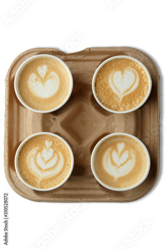 coffee in cardboard cups on the stand. The concept of coffee with you. Lathearte. look from above. Isolated on a white background