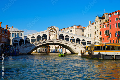 Grand Canal and Rialto bridge  Venice  Italy. beautiful summer day in Italy. Beautiful view of traditional gondola on famous Rialto Bridge. Vacation in romantic Italian city on water. 