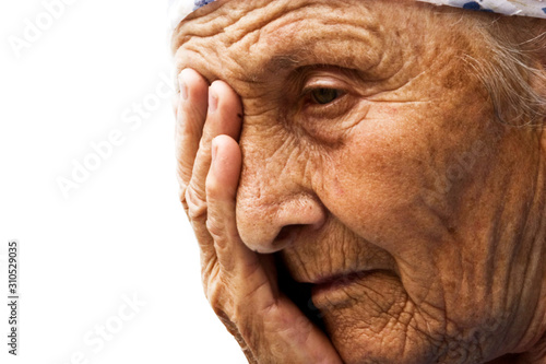 Sad old grandmother close-up. The face of an old grandmother.