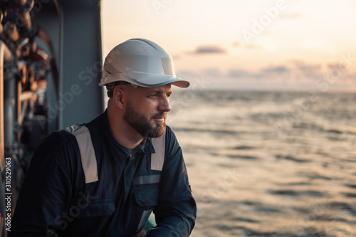 Konstfotografi Marine Deck Officer or Chief mate on deck of offshore vessel or ship , wearing PPE personal protective equipment - helmet, coverall