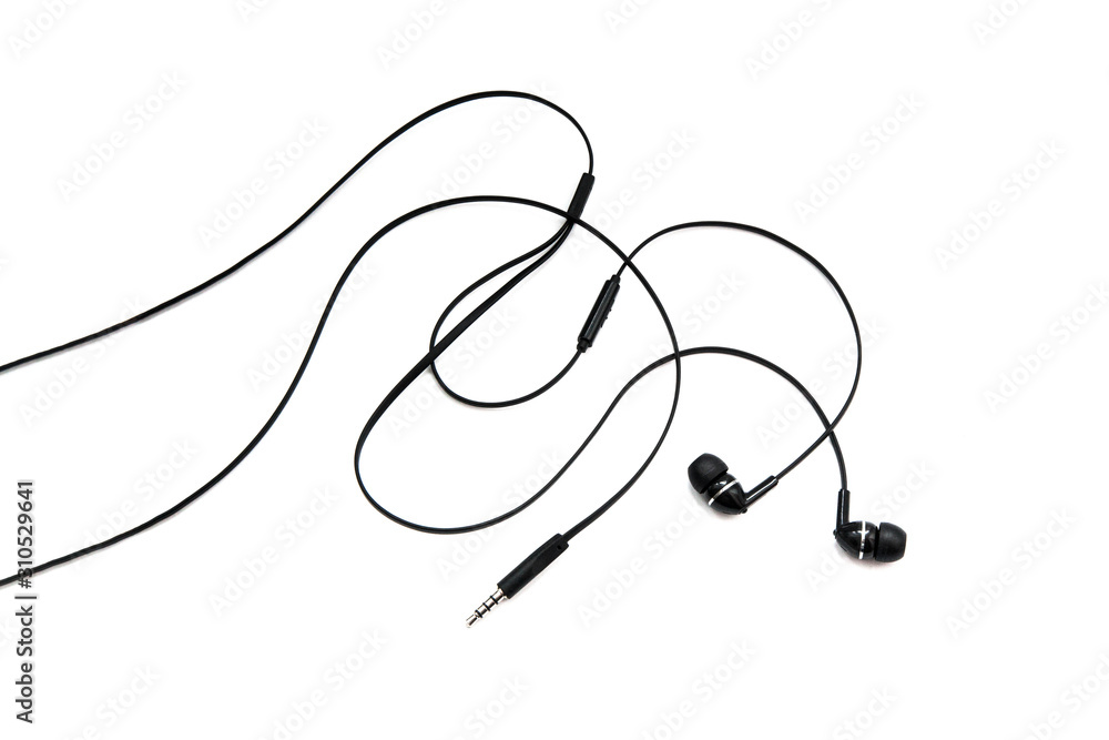 Earphones headset. In-ear headphones. Vacuum wired black headphones for listening to music and sound on portable devices on a white background. Ear plugs for music lovers. Earphones headset. In-ear headphones. Vacuum wired black headphones for listening to music and sound on portable devices on a white background. Ear plugs for music lovers.