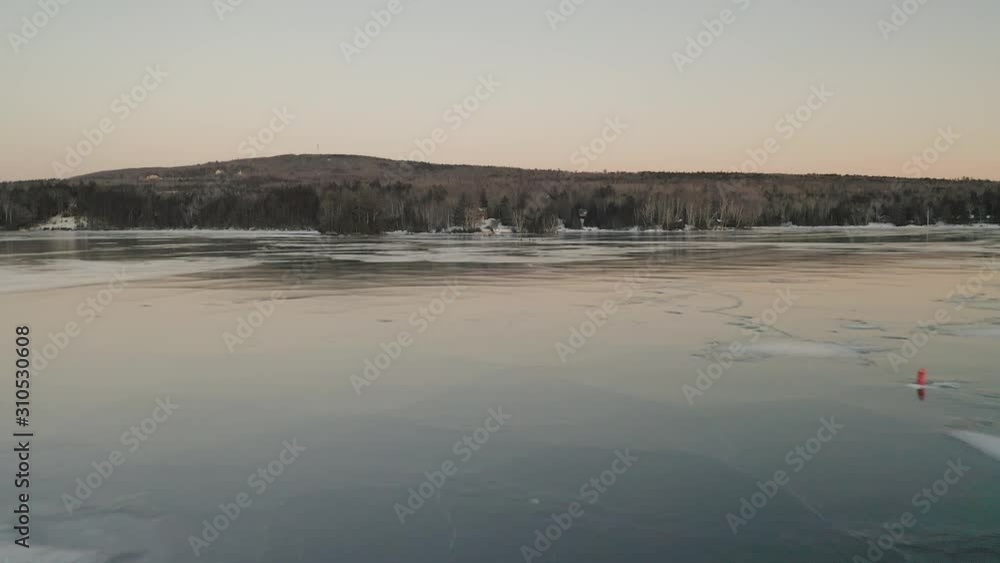 Drone lowering flight over Lake Moosehead in winter, Maine. USA Drone lowering flight over Lake Moosehead in winter, Maine. USA