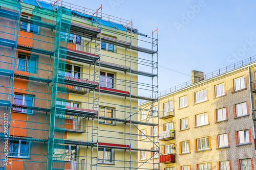 scaffolding arround the house to install thermal insulation of the apartment building facade