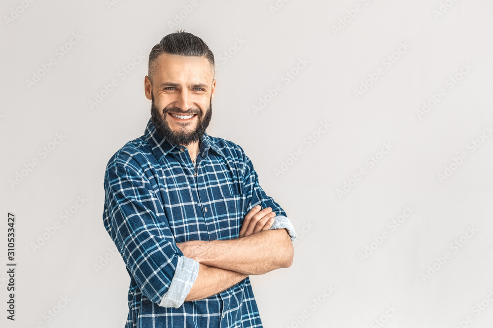 Freestyle. Guy in checkered shirt standing isolated on white crossed arms laughing cheerful Freestyle. Guy in checkered shirt standing isolated on white crossed arms laughing cheerful