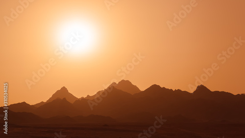 sun over mountain range  abstract