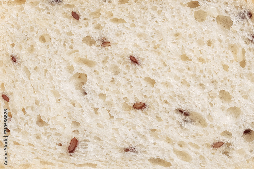 Texture of sliced wheaten bread with flax seed. Flat lay, top view, close-up. Copy space