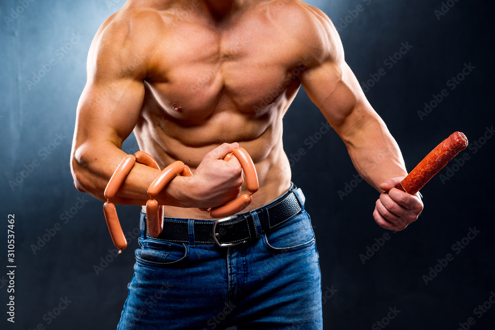 Bodybuilder athlete with naked torso playing muscles with smoked