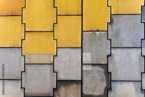 Yellow and Gray Dirty Plaster Wall pattern of bridge, With Falling Off Flakes Of Paint. Rough Surface. Old Weathered Painted Background Texture. Vintage Timber Background. 