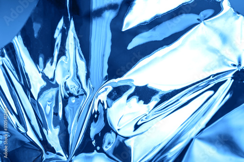Bright holographic foil background. Blue trendy backdrop.