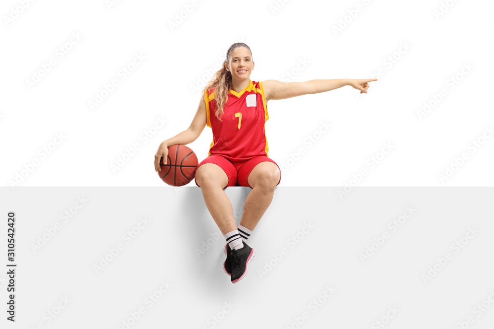 Woman basketball player on a blank board pointing to the side Woman basketball player on a blank board pointing to the side
