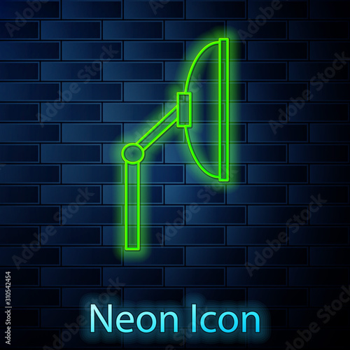 Glowing neon line Windscreen wiper icon isolated on brick wall background. Vector Illustration