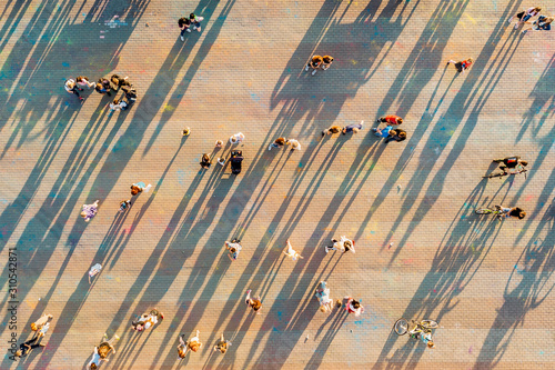 A crowd of people at the festival on the square in the city, top view