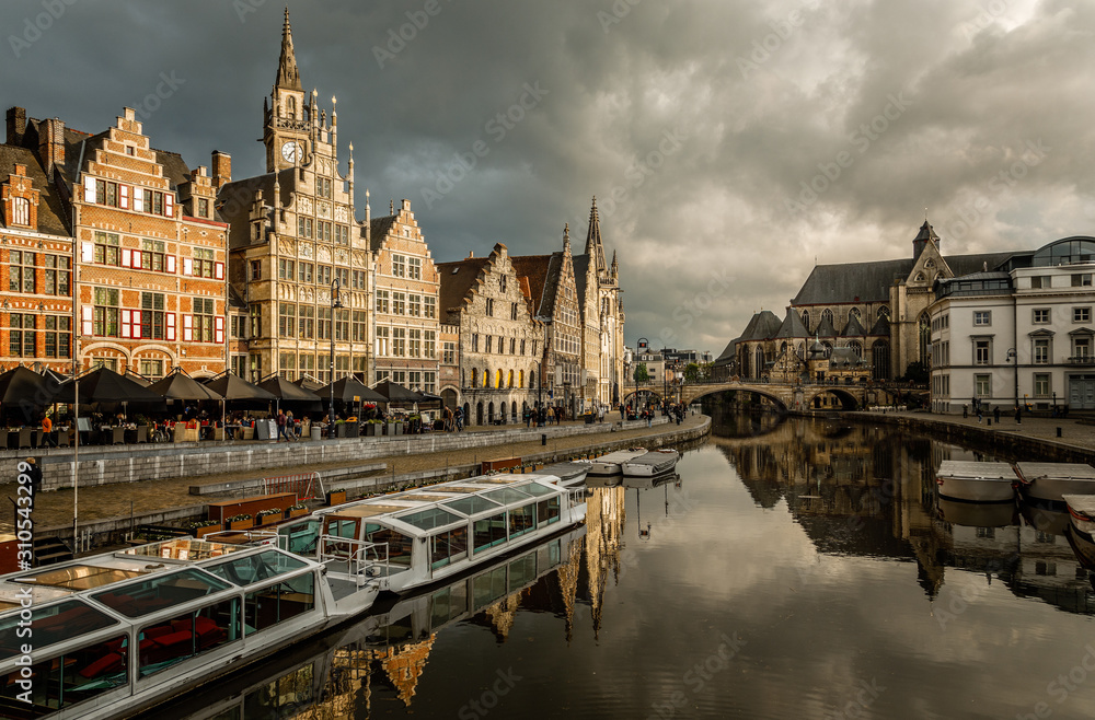 Obraz premium Graslei quay in the historic city center of Ghent, with boats bridge and old flemish buildings, Belgium