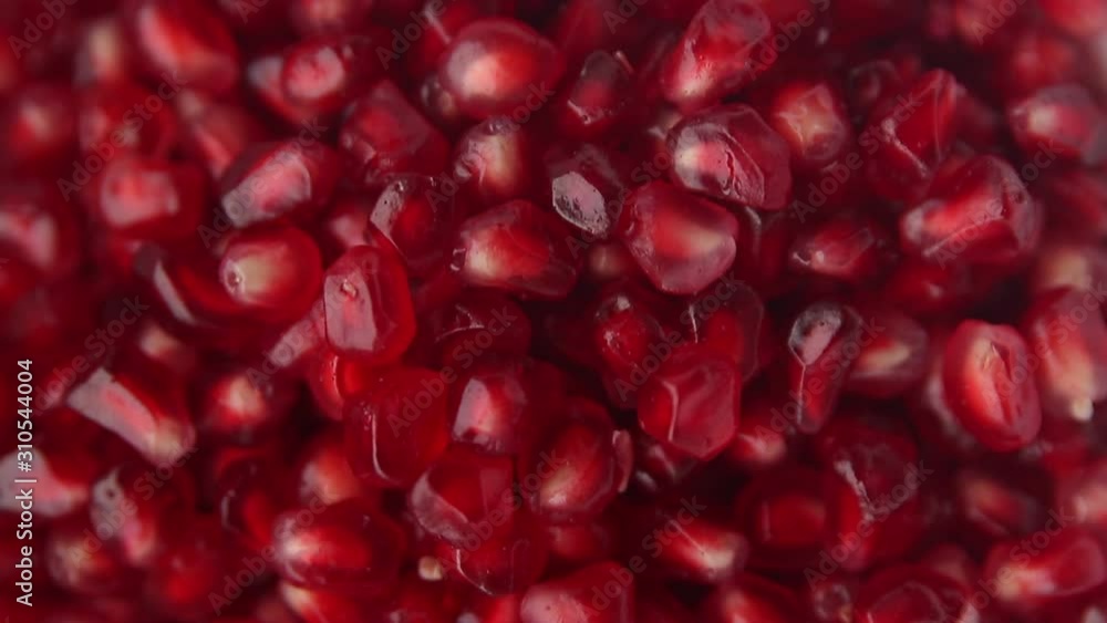 Pomegranate berries close-up in a white plate Pomegranate berries close-up in a white plate