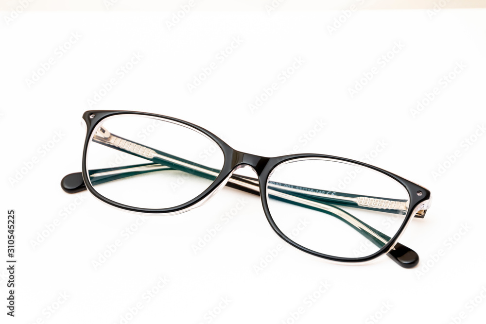 Folded fashion reading glasses for woman on white background Folded fashion reading glasses for woman on white background