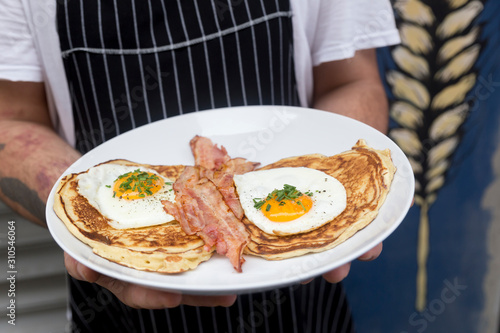 Wallpaper Mural Cook's hands with salted waffles, bacon and eggs Torontodigital.ca