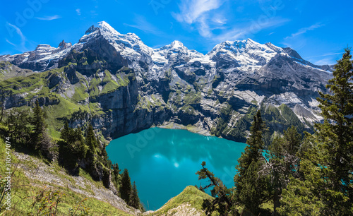 Panorama view of Oeschinensee (Oeschinen lake) on Bernese Oberland in Switzerland on a sunny summer day