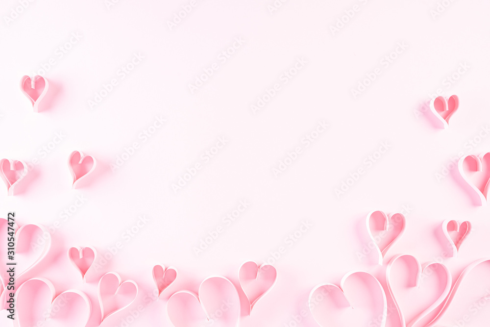 Pink paper hearts on Light pink pastel paper background. Love and Valentine's day concept.