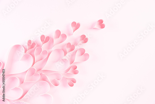 Pink paper hearts on Light pink pastel paper background. Love and Valentine's day concept.