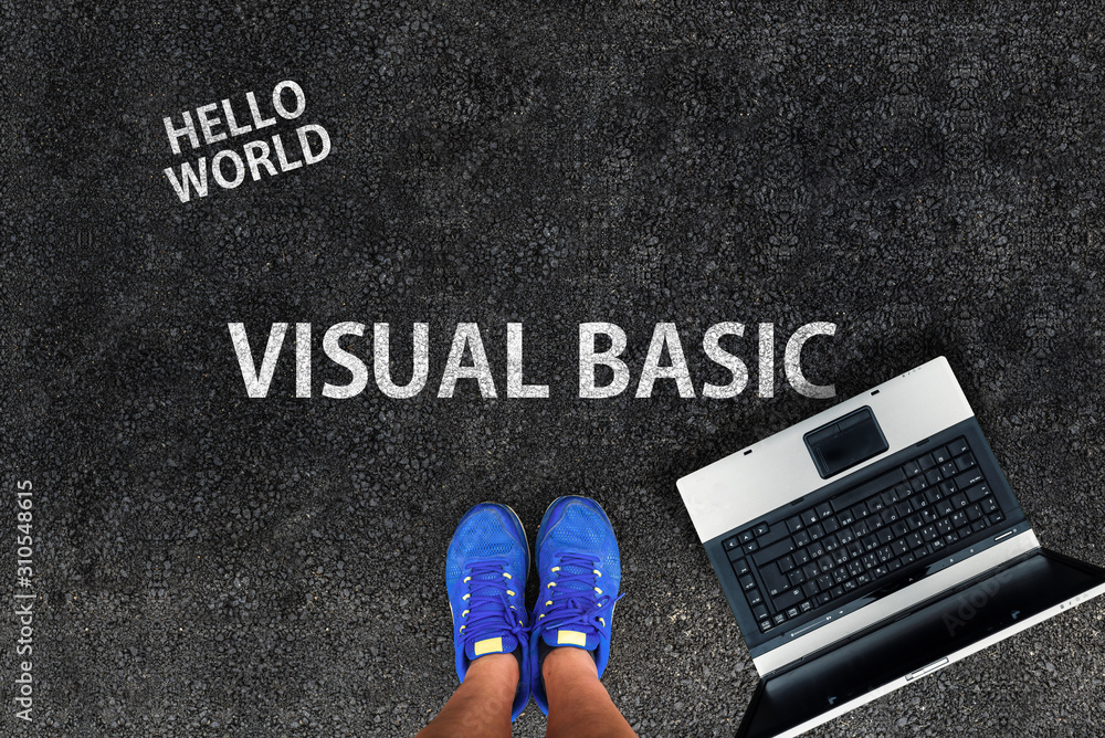 man legs in sneakers standing next to laptop and words Visual Basic ...
