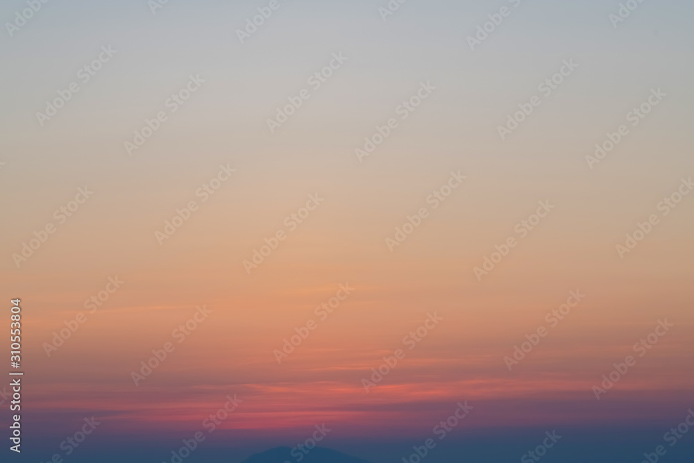 Orange horizon and blue atmosphere. Smooth orange blue gradient of dawn sky.