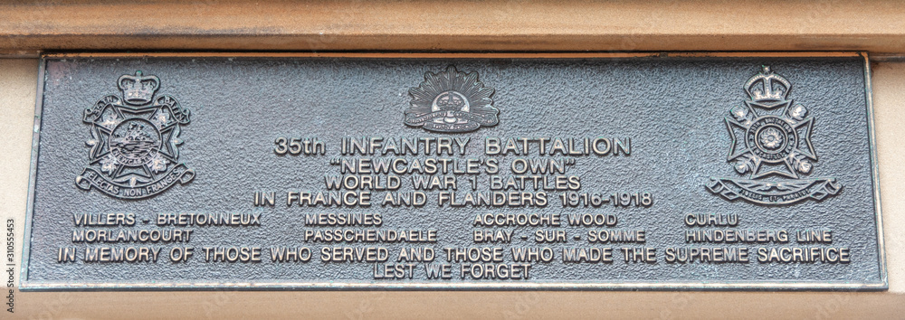 Newcastle, Australia - December 10, 2009: Closeup of black metal plate remembering battles in Flanders at WW1 35th infantry battalion memorial. 